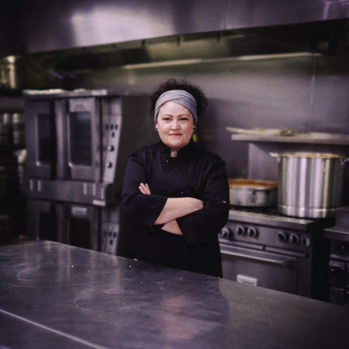 Chef Martina Topete stands in Kitchen